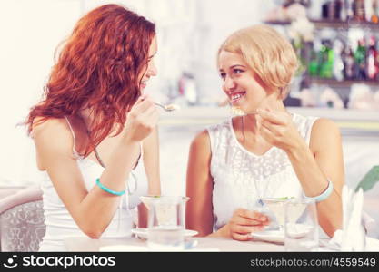 Two pretty female friends meeting in cafe. Friend chat at cafe