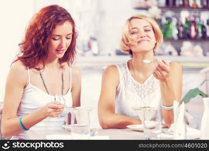 Two pretty female friends meeting in cafe. Friend chat at cafe