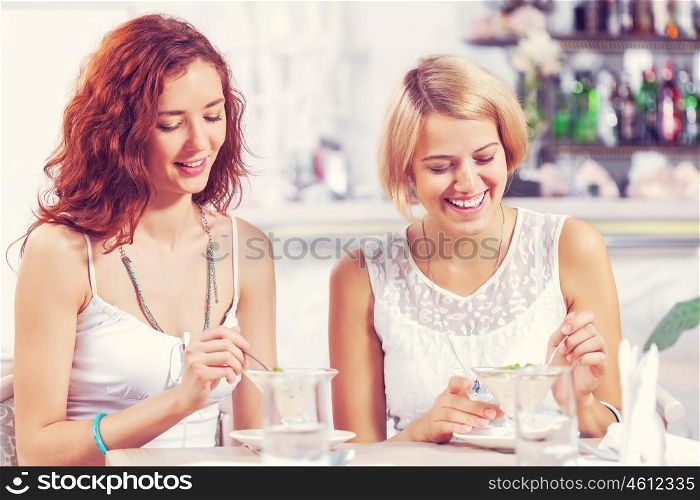 Two pretty female friends meeting in cafe. Friend chat at cafe