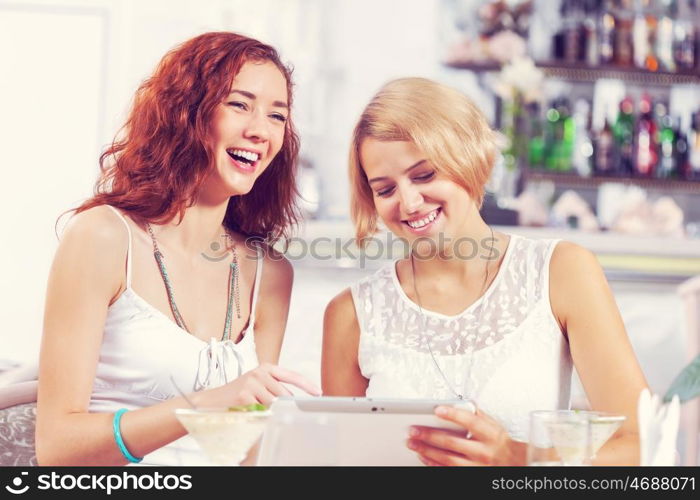 Two pretty female friends meeting in cafe. Friend chat at cafe