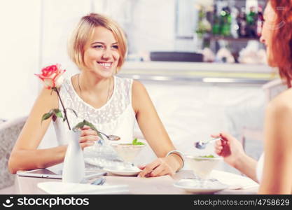 Two pretty female friends meeting in cafe. Friend chat at cafe