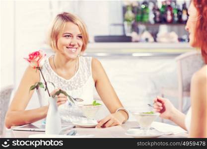 Two pretty female friends meeting in cafe. Friend chat at cafe