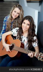 Two pretty girls playing guitar at home