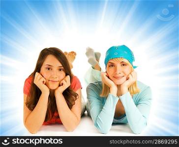 Two pretty teenage girls isolated on abstract background