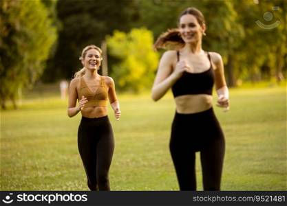 Two pretty young women running in the park