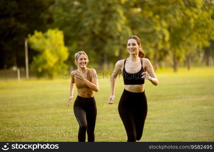 Two pretty young women running in the park