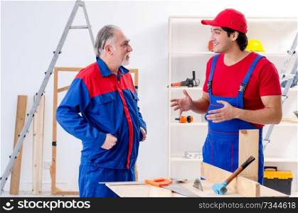 Two professional contractors laying flooring at home  