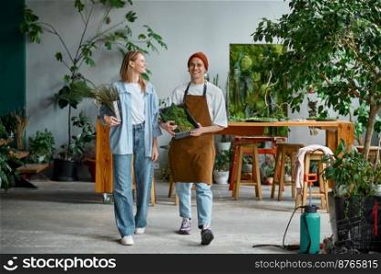 Two professional floral artist at creative art studio. Happy smiling young man and woman holding flowers and moss for creative composition. Floristry, handmade and small business concept. Professional floral artist at creative art studio