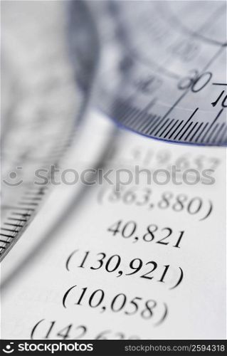 Two protractors on a financial document