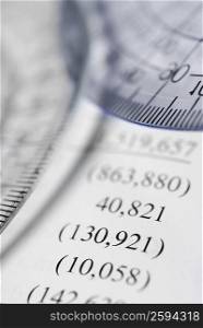 Two protractors on a financial document