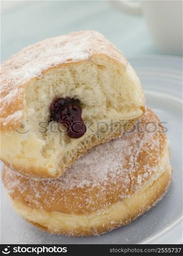 Two Raspberry Jam Doughnuts with a bite