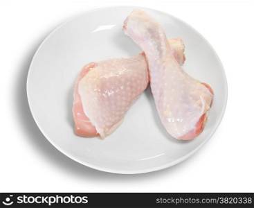 Two Raw Chicken Legs On White Plate Isolated On White Background