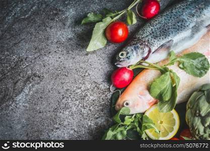 Two raw Trout fishes with fresh vegetables ingredients for healthy clean cooking, top view, copy space