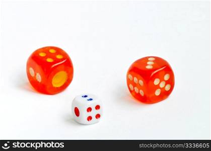 Two red and one white dices on a white background