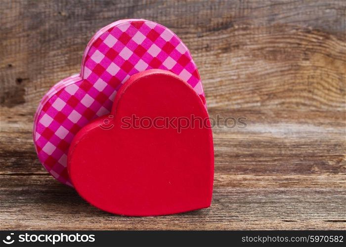 two red and pink hearts. pair of red and pink hearts laying together on wooden background