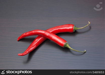 Two red chili peppers on the kitchen table