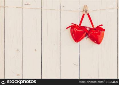 Two red heart hanging on white wood with space for Valentine and Wedding background.