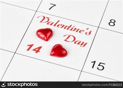 Two red hearts on the calendar with the inscription Valentine&rsquo;s Day. Background for a greeting card for Saint Valentine&rsquo;s Day ore wallpaper