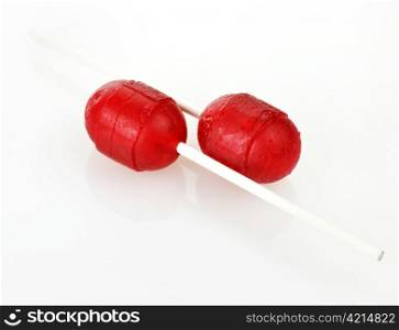 two red lollipops on a white background