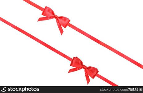 two red satin bows and two diagonal ribbons isolated on horizontal white background