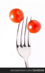 two red tomatos cherry on cogs the fork
