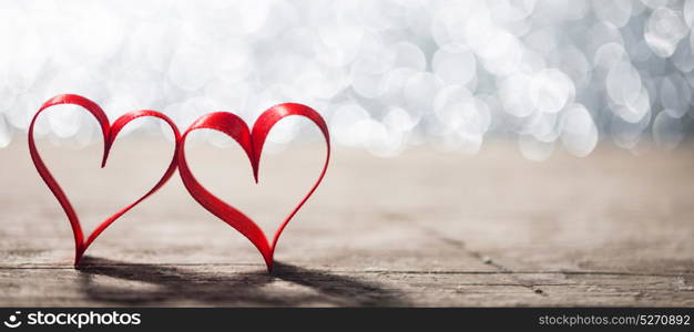 Two ribbon hearts on wood. Two red ribbon hearts on wooden backround, Valentine day concept