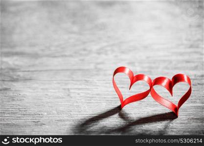 Two ribbon hearts on wood. Two red ribbon hearts on wooden backround, Valentine day concept