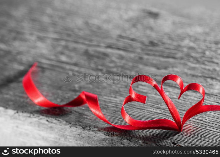 Two ribbon hearts on wood. Two red ribbon hearts on wooden backround, Valentine day concept