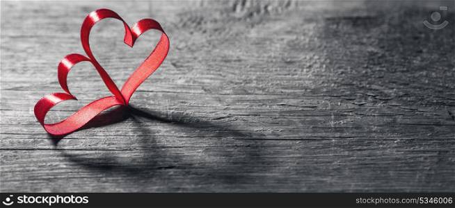Two ribbon hearts on wood. Two red ribbon hearts on wooden backround, Valentine day concept