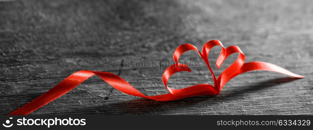 Two ribbon hearts on wood. Two red ribbon hearts on wooden backround, Valentine day concept