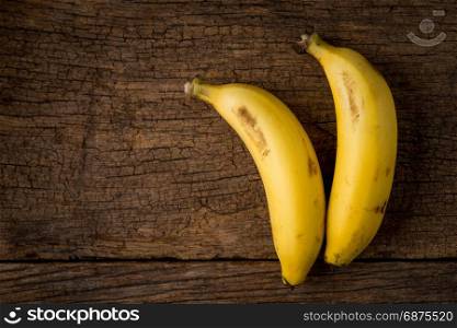 two ripe bananas on wooden table