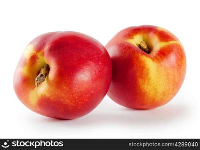 Two ripe juicy nectarine isolated on white background