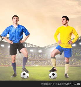 two rival soccer or football players. two rival soccer or football players are standing on stadium