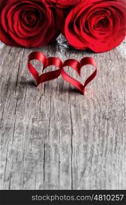 Two roses and ribbon hearts on wooden background, Valentines day