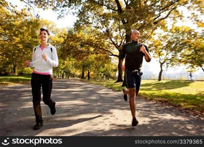 Two runners in a park with slight motion blur