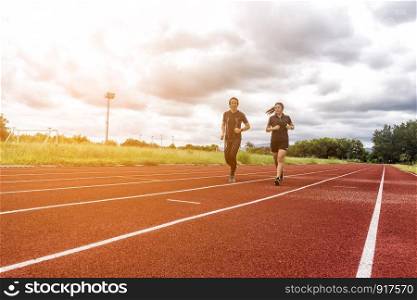 Two runners jogging on the race track, Sport and Social activity concept