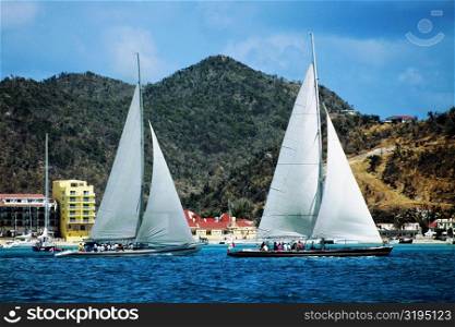 Two sailboats are seen participating in the Heiniken Regatta on the Dutch side of the island of St. Maarten in the Caribbean