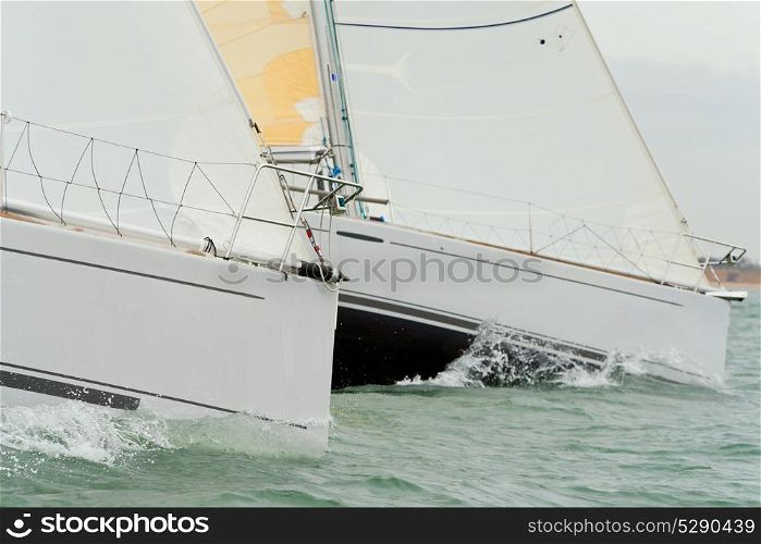 Two sailing boats, sail boats or yachts at sea