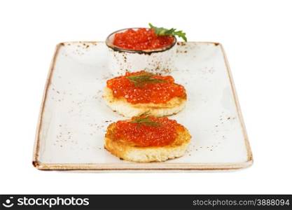 Two sandwiches with red caviar on a porcelain plate