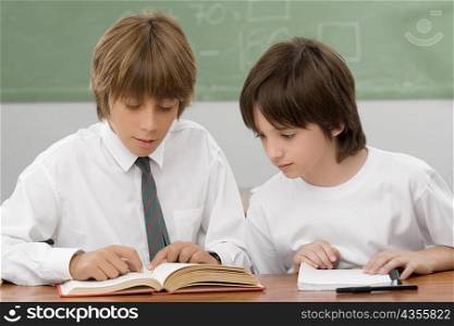 Two schoolboys studying in a classroom
