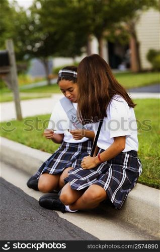 Two schoolgirls sitting together