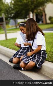 Two schoolgirls sitting together