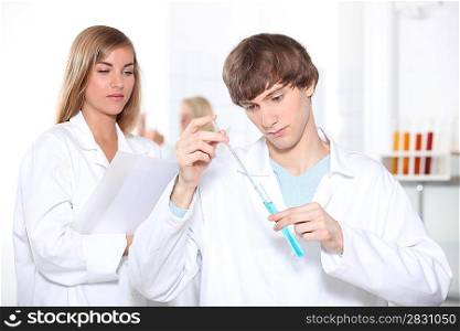 Two science students working in laboratory