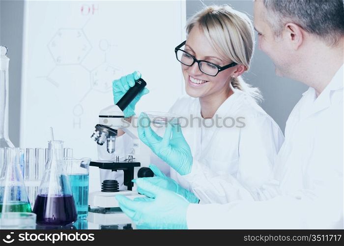 two scientist in chemical lab conducting experiments