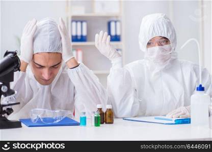 Two scientists working in the chemical lab