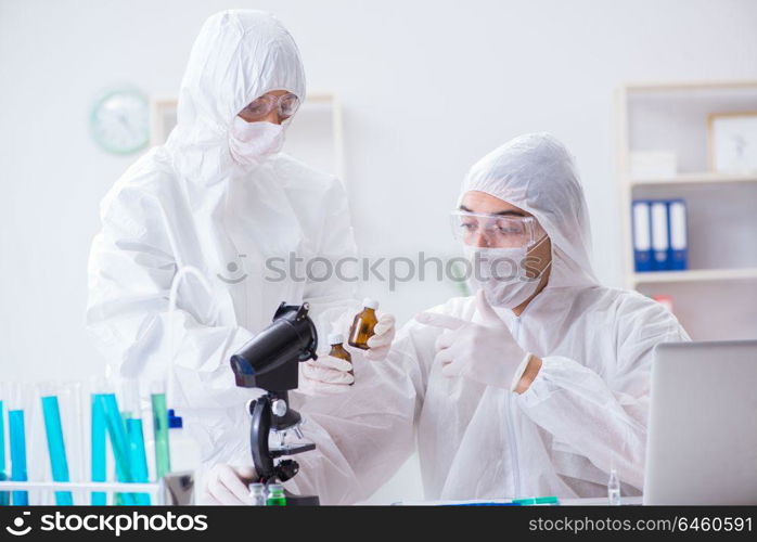 Two scientists working in the chemical lab