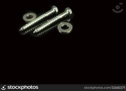two screws and washers on a black background