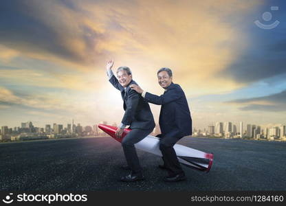 two senior business man riding on children rocket toy standing on asphalt ground with urban scene background for humor business concept