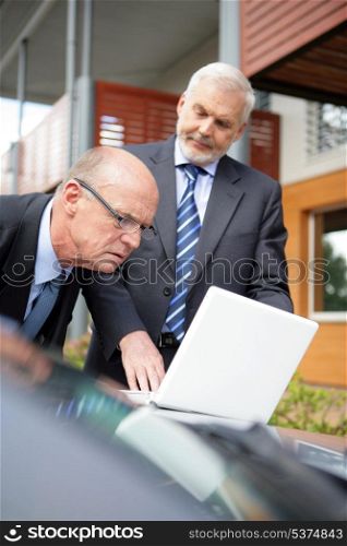 Two senior businessmen on a sales call