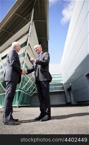 Two senior businessmen shaking-hands